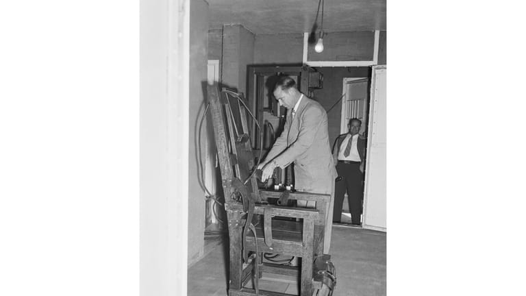 An unidentified attendant checks Louisiana's portable electric chair in the...