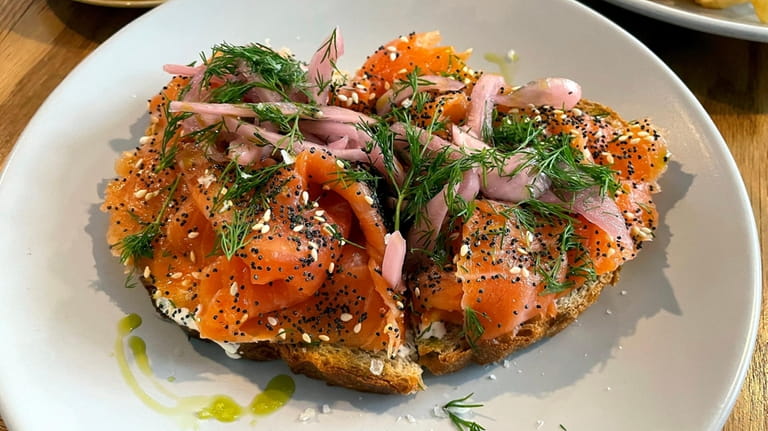 Smoked salmon over crème fraiche on toast with pickled onions...