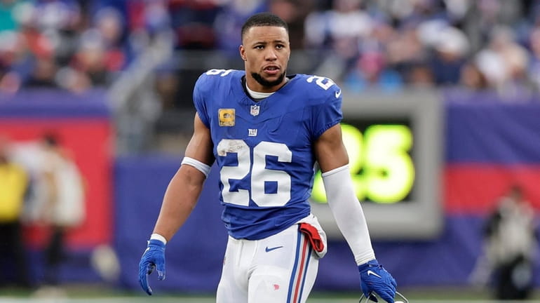 Saquon Barkley #26 of the Giants looks on during the...