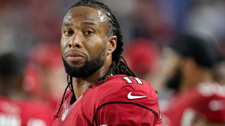 Larry Fitzgerald of the Arizona Cardinals watches from the sidelines...