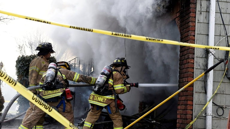 Firefighters battle the blaze in Oakdale on Sunday, Dec. 24,...