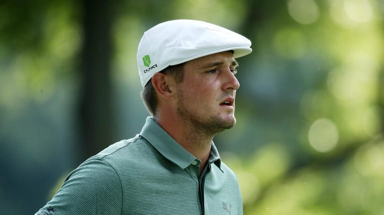 Bryson DeChambeau stands on the 18th hole during the third...