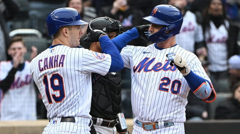 The Mets' Mark Canha greets Pete Alonso after his two-run...