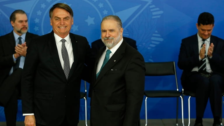 Brazil's President Jair Bolsonaro poses for a photo with his...