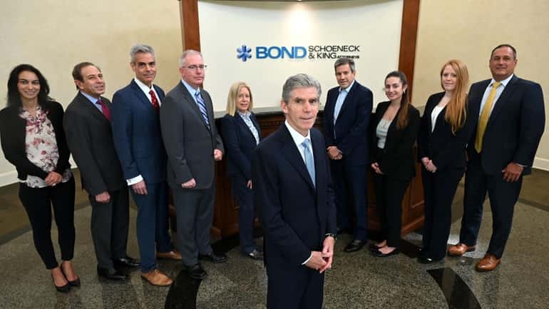 Attorney Ralph Rosella, at center, with his colleagues at Bond,...