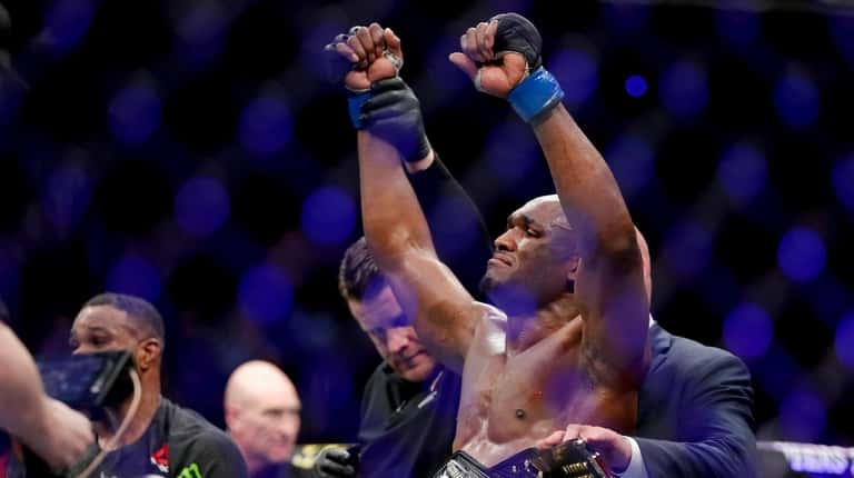 Kamaru Usman celebrates after his win against Tyron Woodley in...