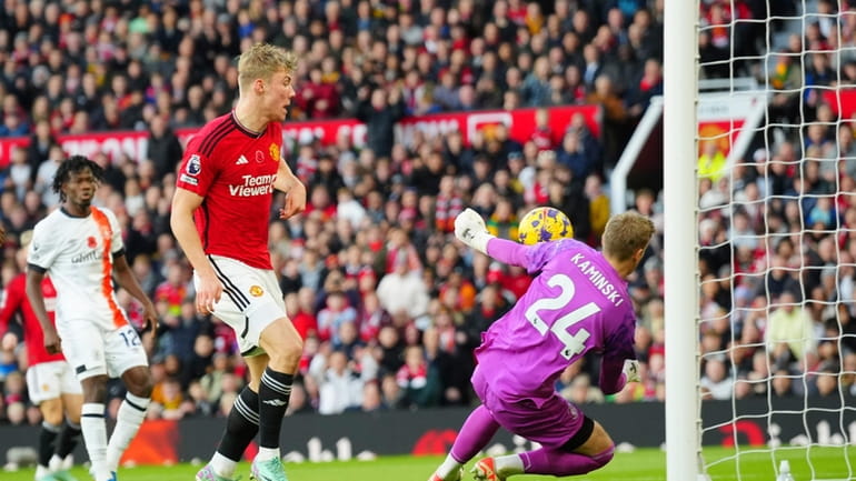 Manchester United's Rasmus Hojlund, centre, makes an attempt to score...