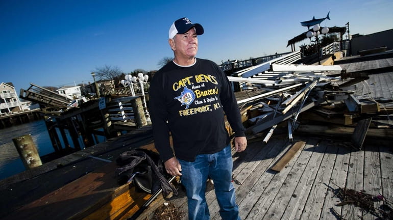 Jerry Bracco, 67, of Freeport, poses on the damaged dock...