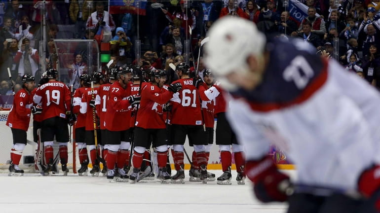 Team Canada celebrates after beating the USA 1-0 in a...