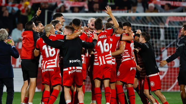 Girona players celebrate at the end of a Spanish La...