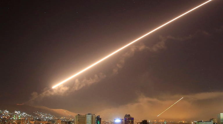 Damascus skies light up as a U.S.-led coalition launches airstrikes...