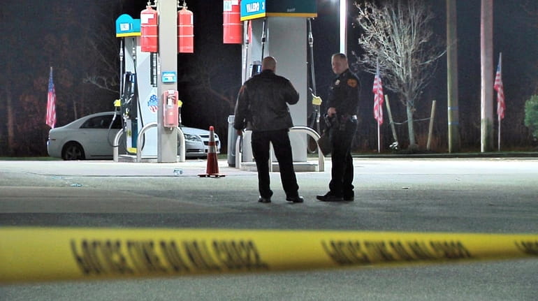 Suffolk County police at a gas station where a shooting of...