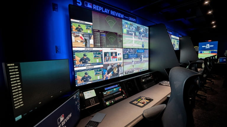 A Major League Baseball umpire is displayed alongside gameplay clips...