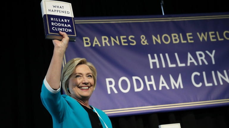 Hillary Clinton with her new memoir, "What Happened," at a...