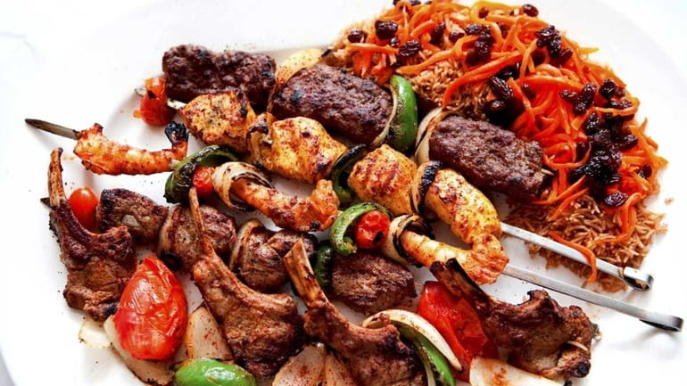 The mixed grill kebab platter is served with pilaf and...