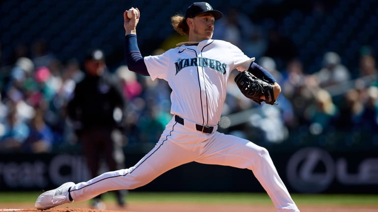 Seattle Mariners pitcher Bryce Miller throws to a Cincinnati Reds...