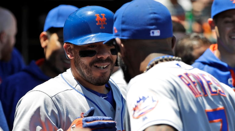 New York Mets' Rene Rivera, left, celebrates his solo home...