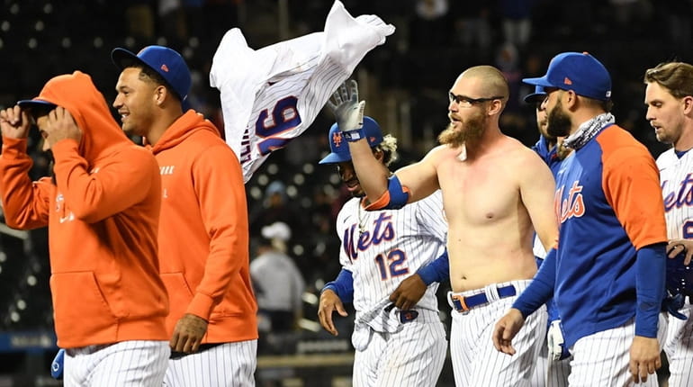New York Mets pinch hitter Patrick Mazeika retrieves his jersey...