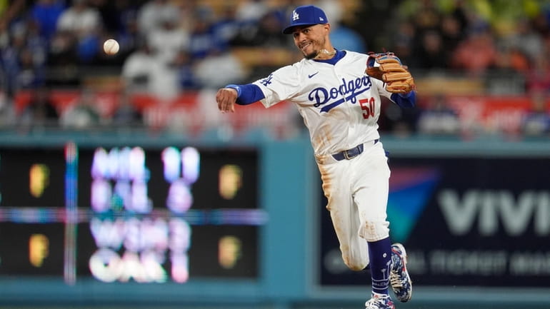 Los Angeles Dodgers shortstop Mookie Betts throws out San Diego...