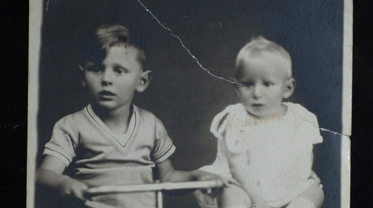 A copy of a 1930 family photograph of brothers Andrew...