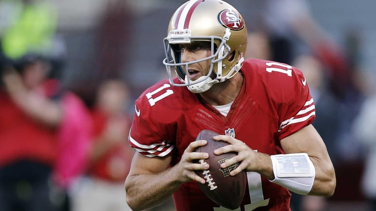 San Francisco 49ers quarterback Alex Smith rolls out during a...