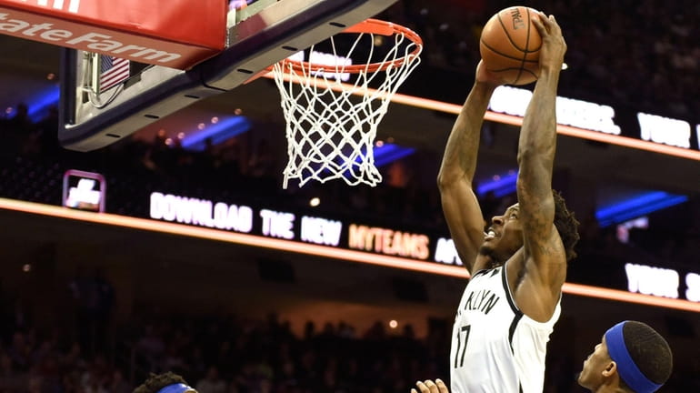 The Nets' Ed Davis (17) goes up for a dunk...