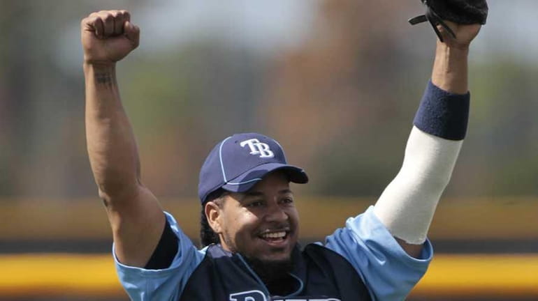 Tampa Bay Rays outfielder Manny Ramirez reacts after catching a...