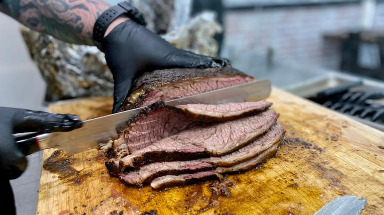 Brisket is sliced at Meat's Meat BBQ Shop in Mattituck,...