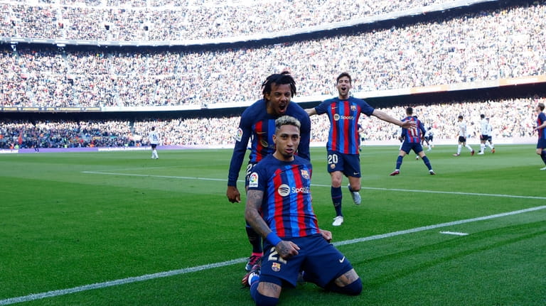 Barcelona's Raphinha celebrates scoring his side's opening goal during Spanish...