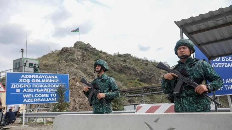 Azerbaijani servicemen guard the Lachin checkpoint on the in Azerbaijan,...