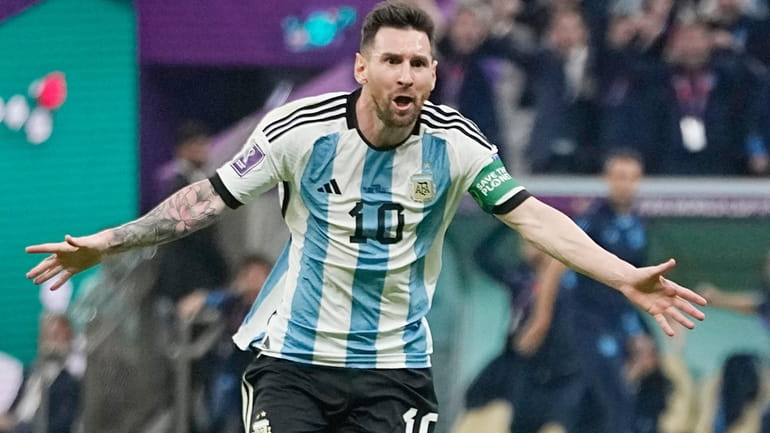 Argentina's Lionel Messi celebrates after scoring his side's opening goal...