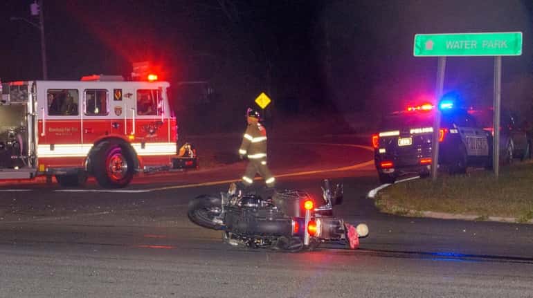 Firefighters at the scene of a motorcycle crash on Route...