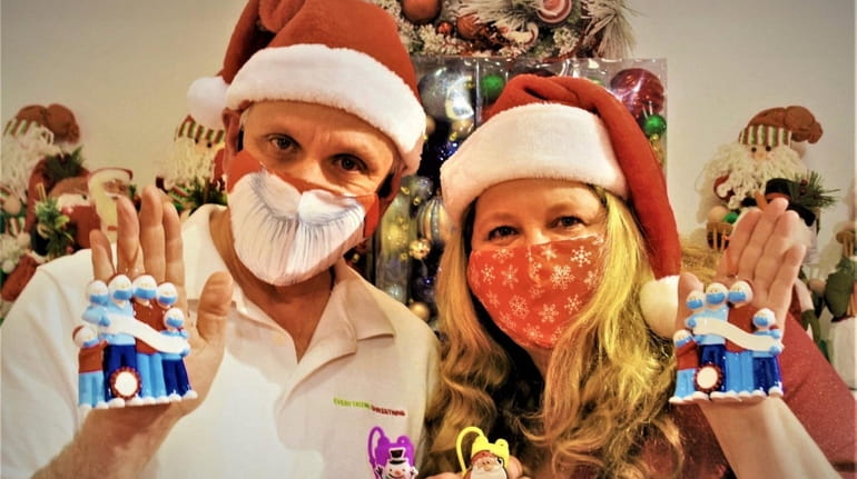 Howie and Pam Frank, owners of Everything Christmas, hold up...