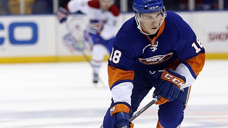 Islanders center Ryan Strome brings the puck up ice in...