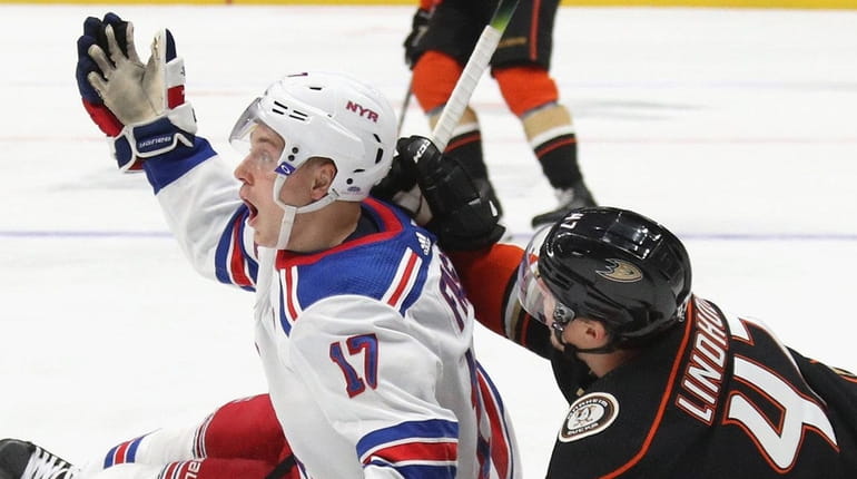 Jesper Fast of the Rangers and Hampus Lindholm of the...