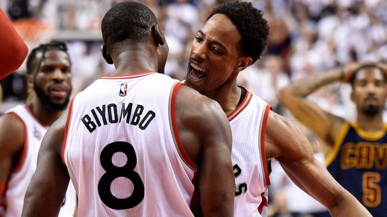 Toronto Raptors center-forward Bismack Biyombo and DeMar DeRozan celebrate during...