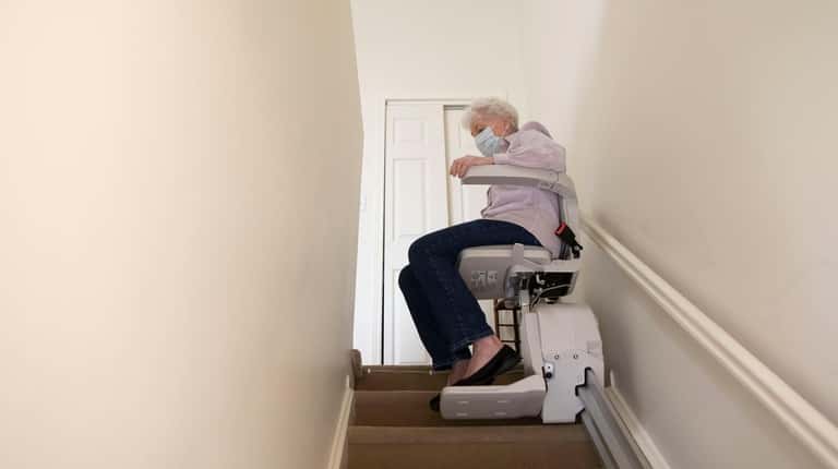 Ellen Connor uses the stair lift in her home in...