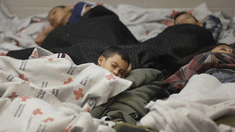 Children detainees sleep in a holding cell at a U.S....