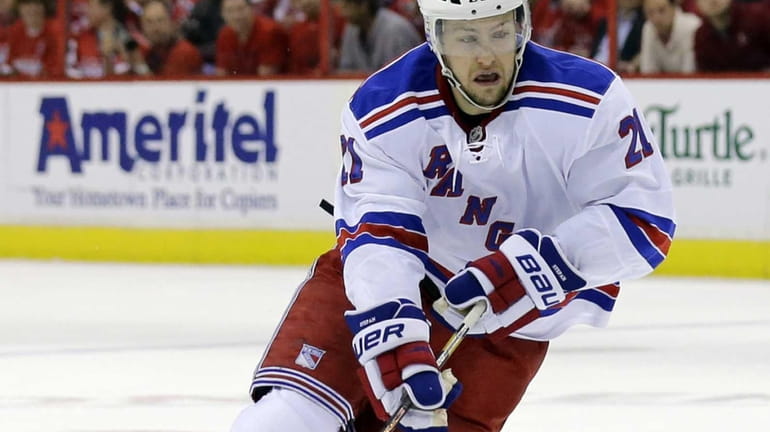 Derek Stepan skates with the puck in the second period...