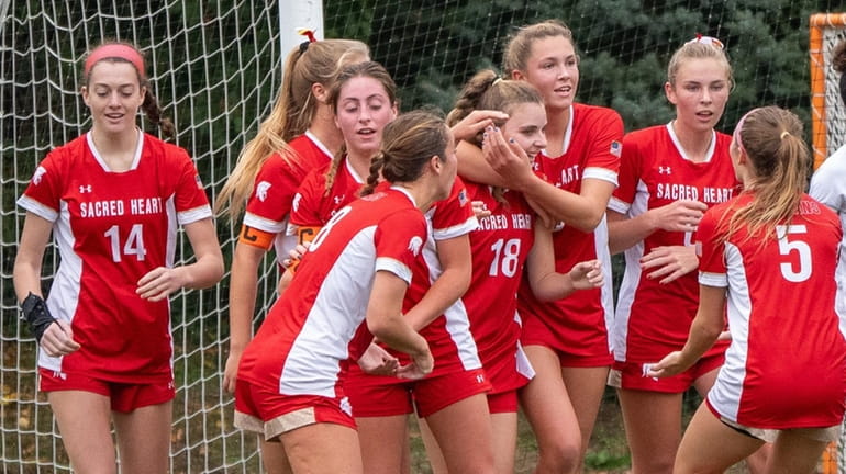 Sacred Heart celebrates after Anne Price scores during a CHSAA girls soccer...