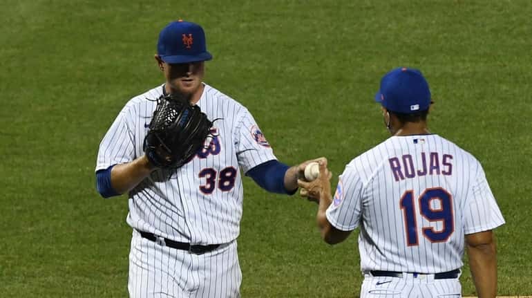 Mets manager Luis Rojas takes the ball from relief pitcher...