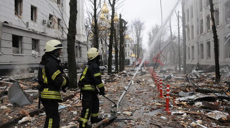 Firefighters extinguish a fire in a Ukrainian Security Service building after...