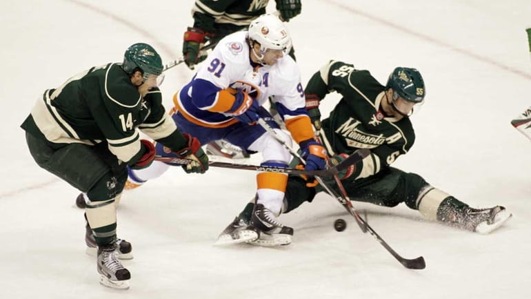 New York Islanders center John Tavares (91) battles for the...