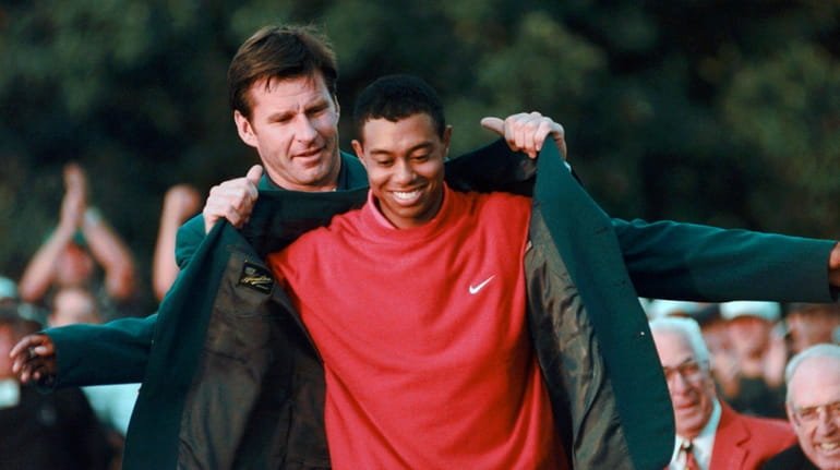 In this April 13, 1997, file photo, Masters champion Tiger...