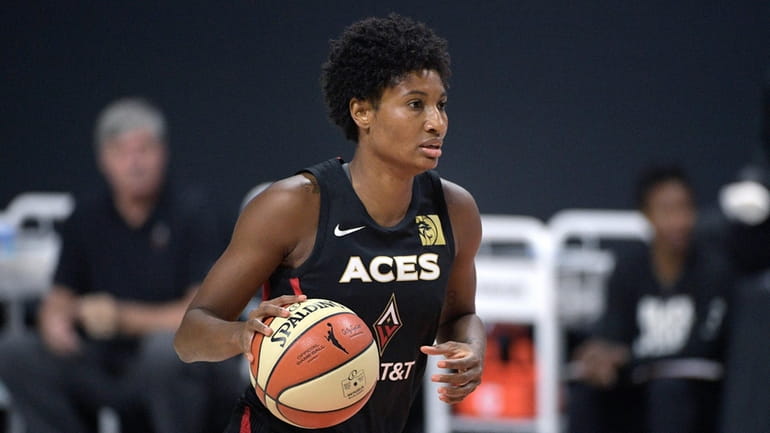 Las Vegas Aces forward Angel McCoughtry sets up a play...