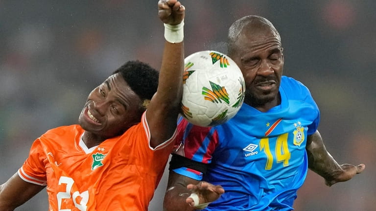 DR Congo's Gael Kakuta, right, battles for the ball with...