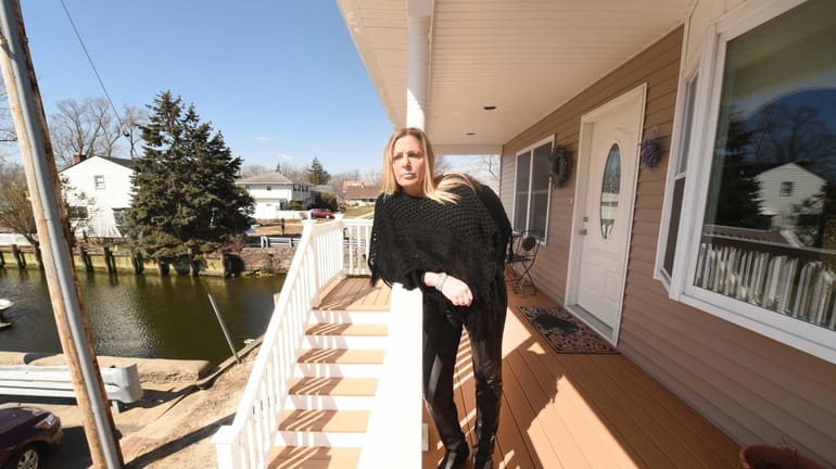 Gail Mero on the front porch of her home, which...