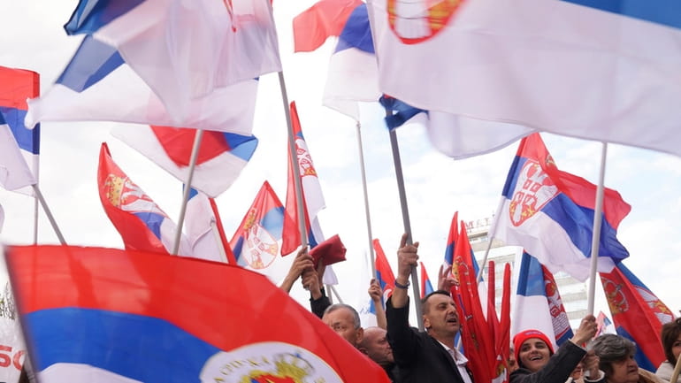 Supporters of Bosnian Serb political leader Milorad Dodik wave Serbian...
