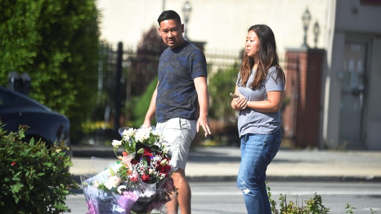 Couple drop off flowers at the scene of the fatal...