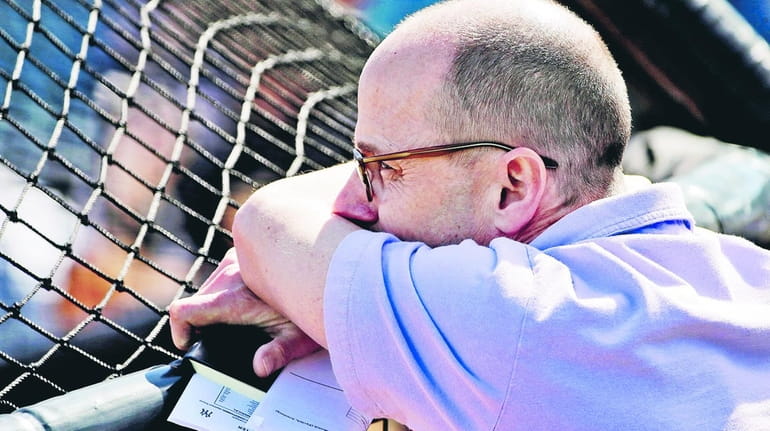 New York Yankees general manager Brian Cashman watches live batting...